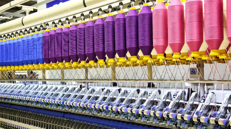 Modern textile mill producing colorful yarn and fabrics with advanced machinery in 2025