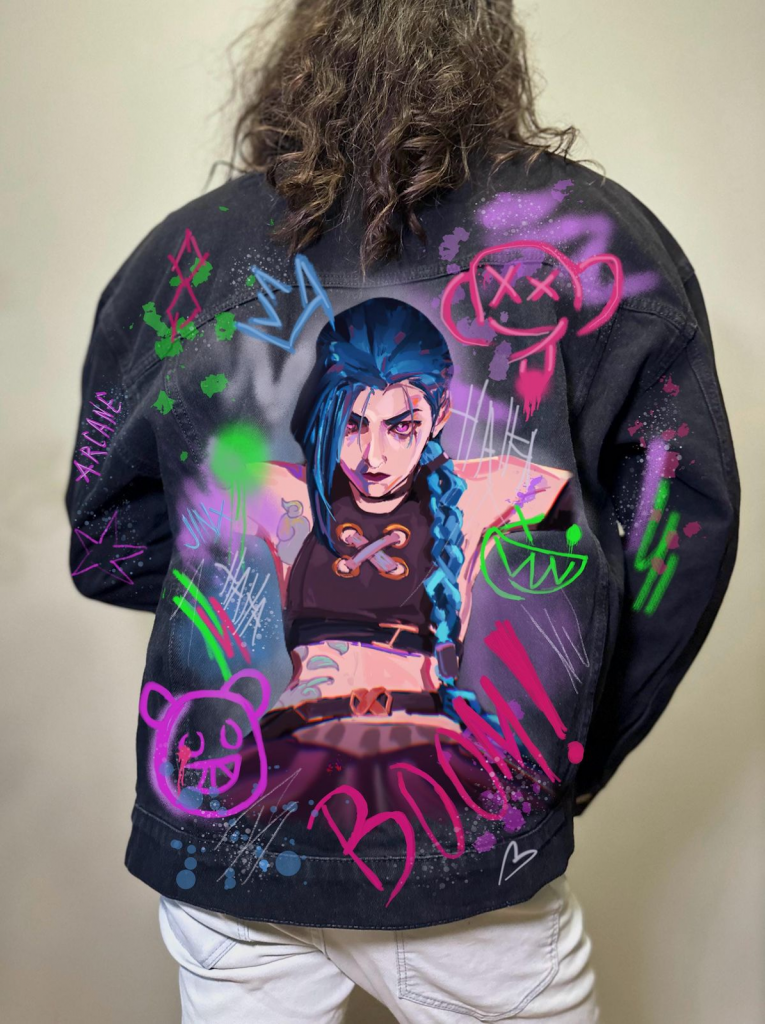 Hand-painted denim jacket with bold graffiti-style artwork of a female character.