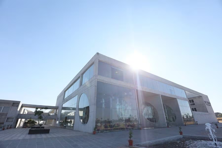 Brutalist concrete architecture of Woxsen University School of Fashion and Design campus in Hyderabad with colorful entrance art installations